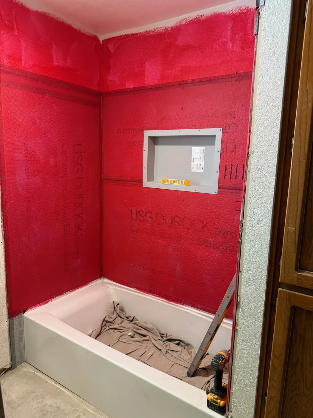Shower niche framed and membrane carried into the corners