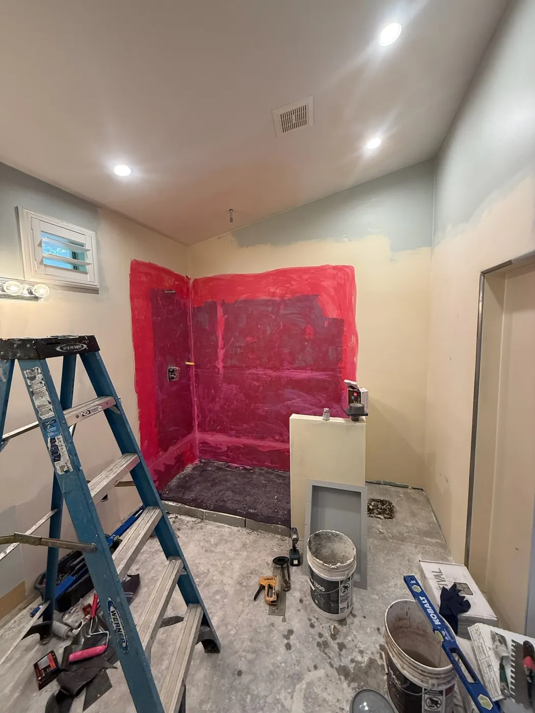 Waterproofing membrane applied over the backer board before tile