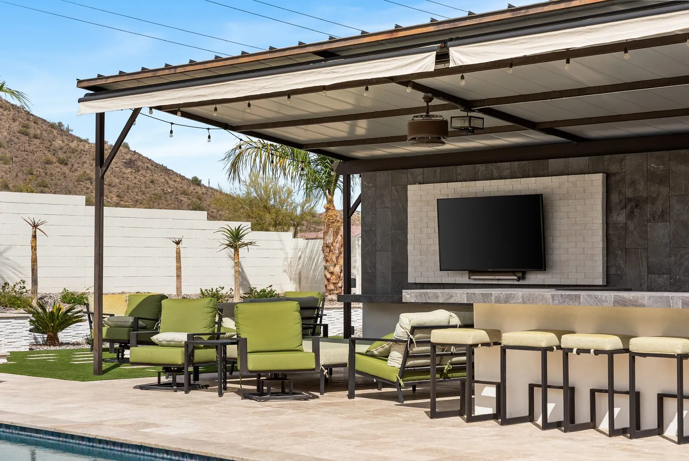 Covered seating and bar stools beneath the steel structure