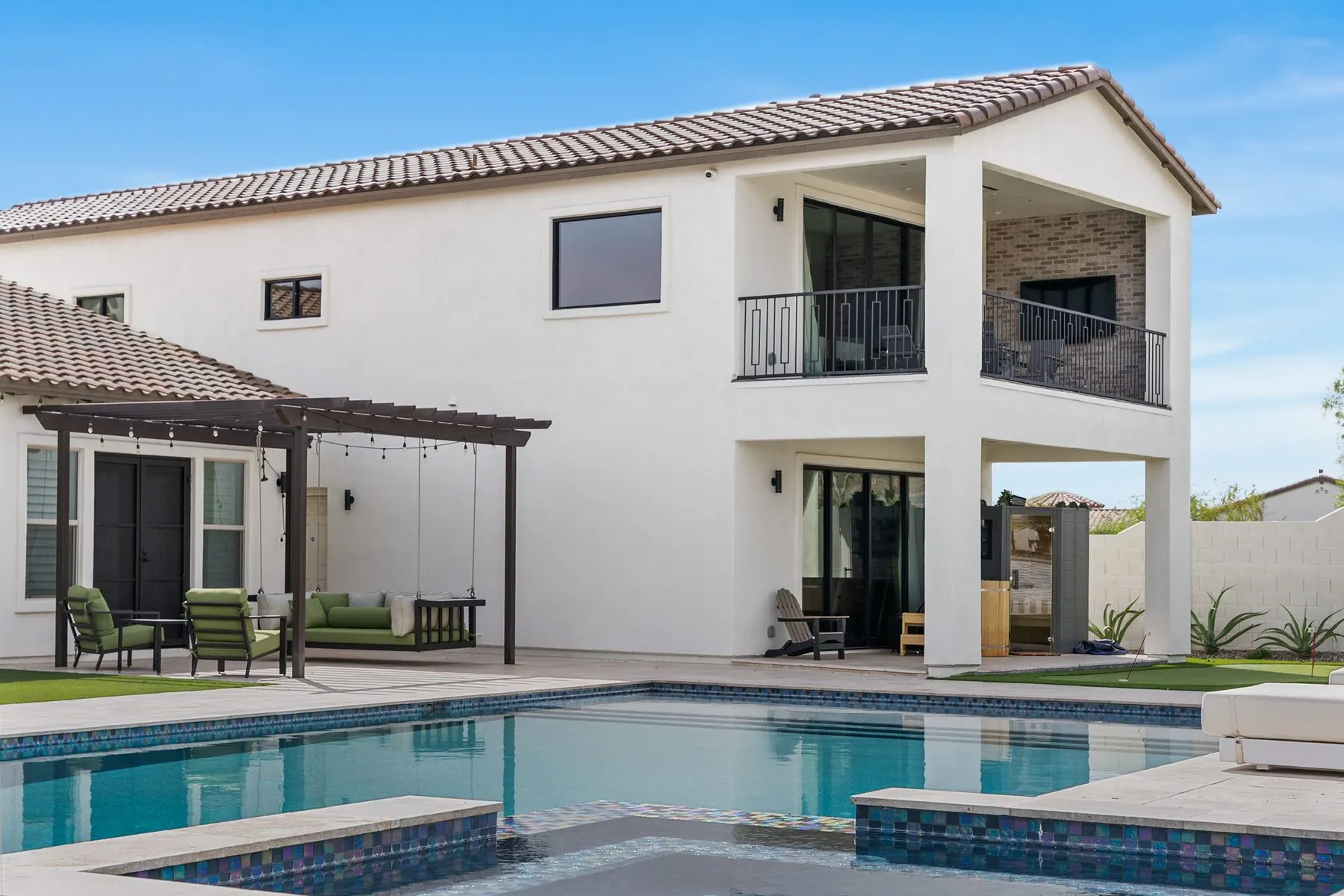 Completed Blackstone Contracting residence with pergola, pool and spa, and turf run