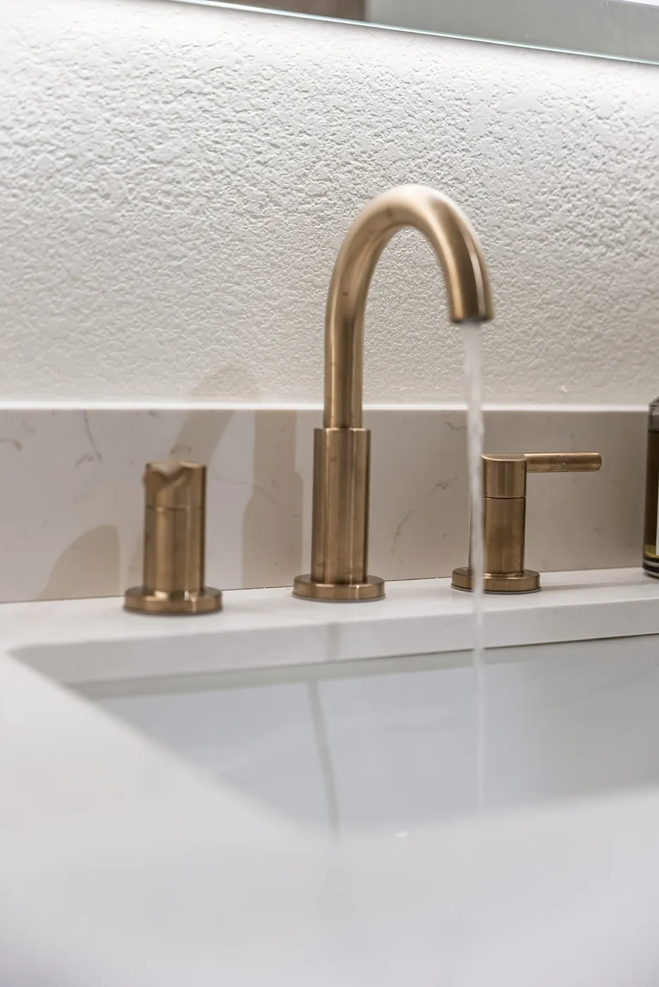Brass faucet and handles at the sink