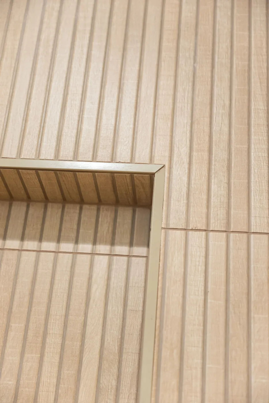 Recessed niche cut into the fluted tile, from the side