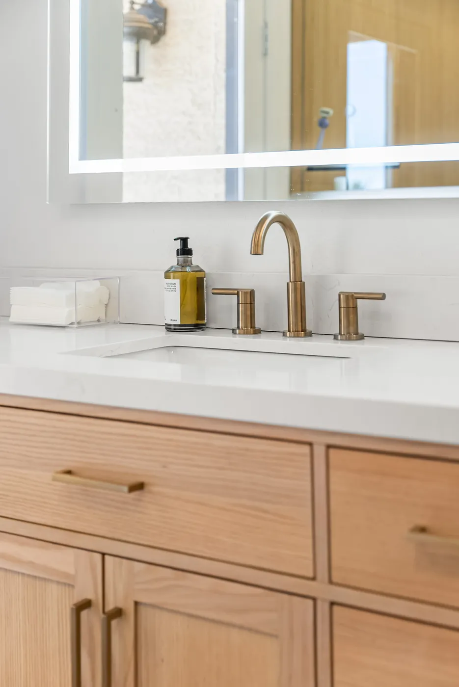Counter edge, undermount sink and brass faucet on the vanity