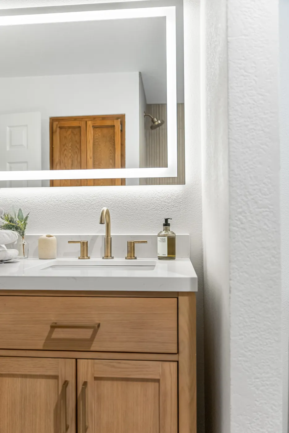 Vanity cabinet and mirror with the door and hallway reflected