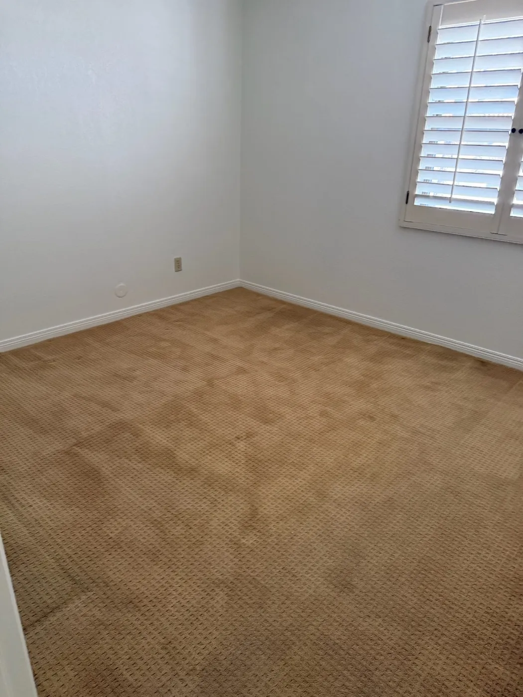 Bedroom before work, with the original carpet still down