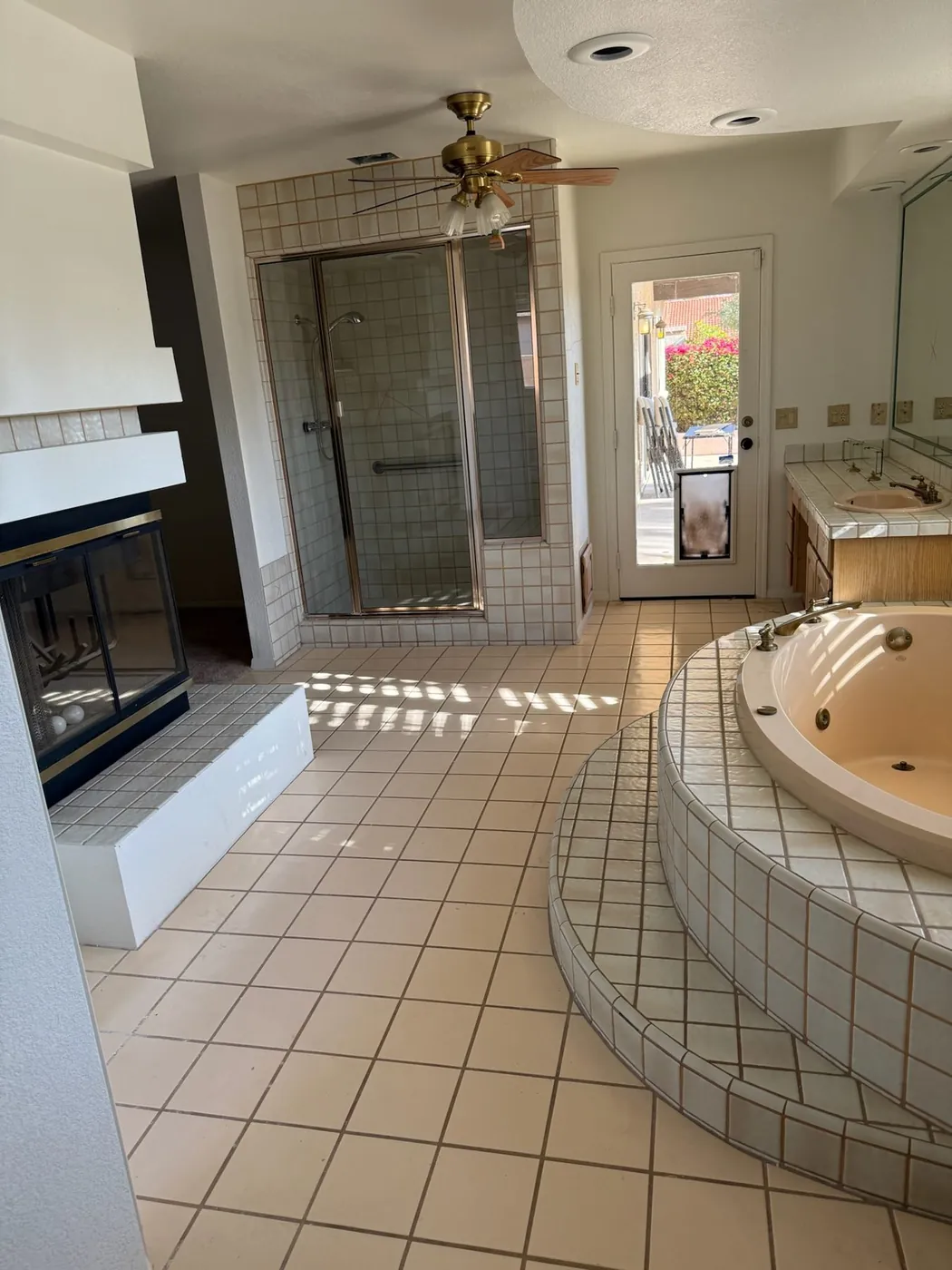 Primary bathroom in its original condition, with a tiled garden tub and glass block