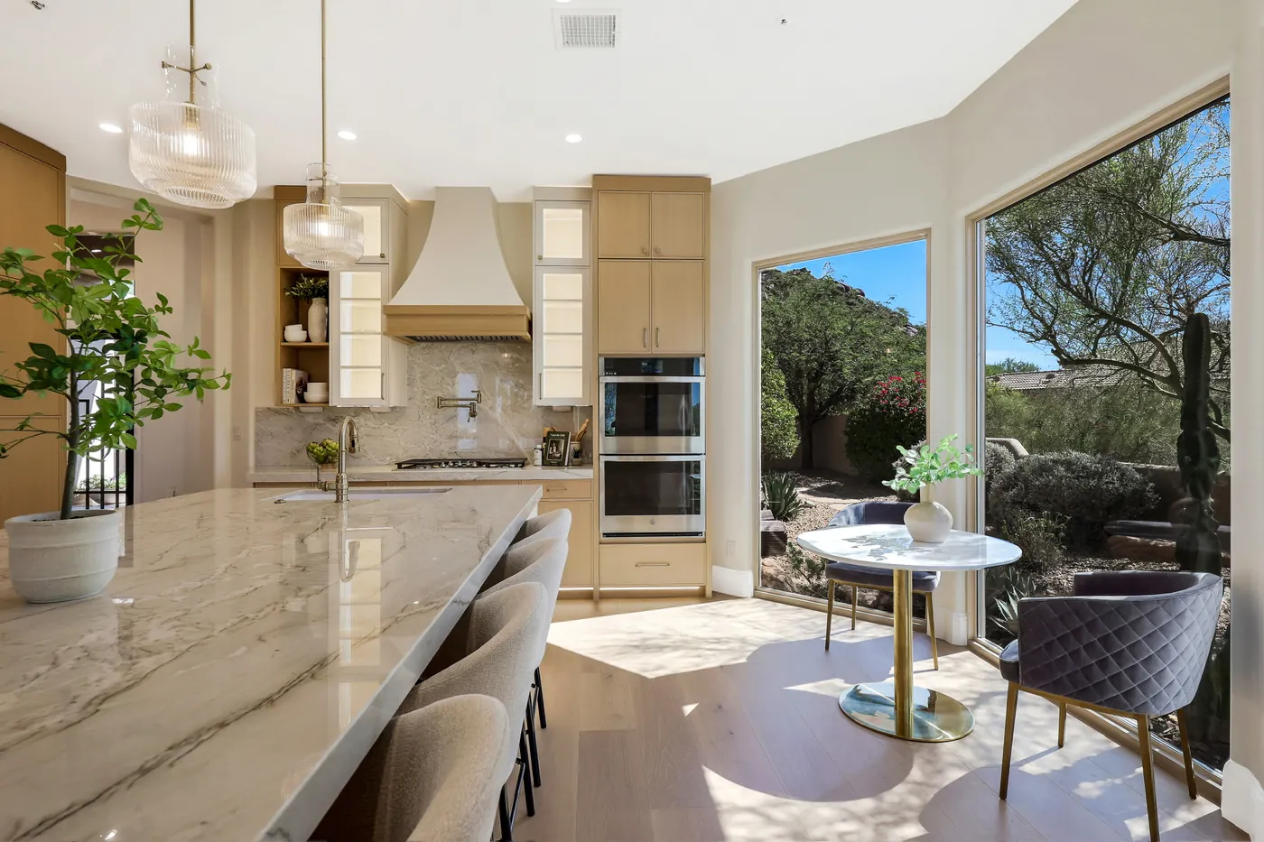 Island seating with the range wall and a run of windows onto the desert