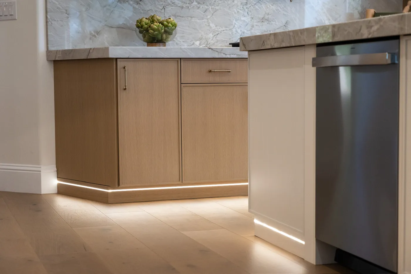 Toe-kick lighting under the light-wood cabinetry