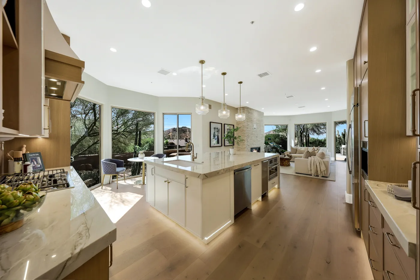 Kitchen looking back across the island toward the living room and view windows