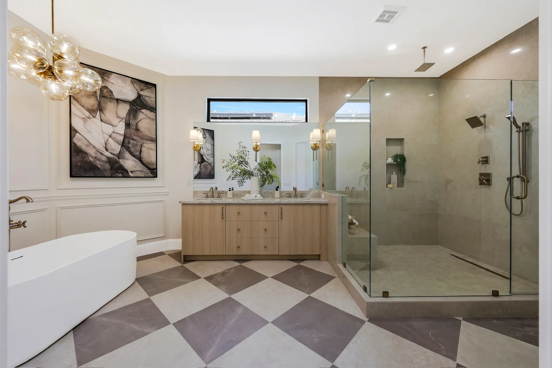 Primary bath with a freestanding tub, glass walk-in shower and checkerboard stone floor