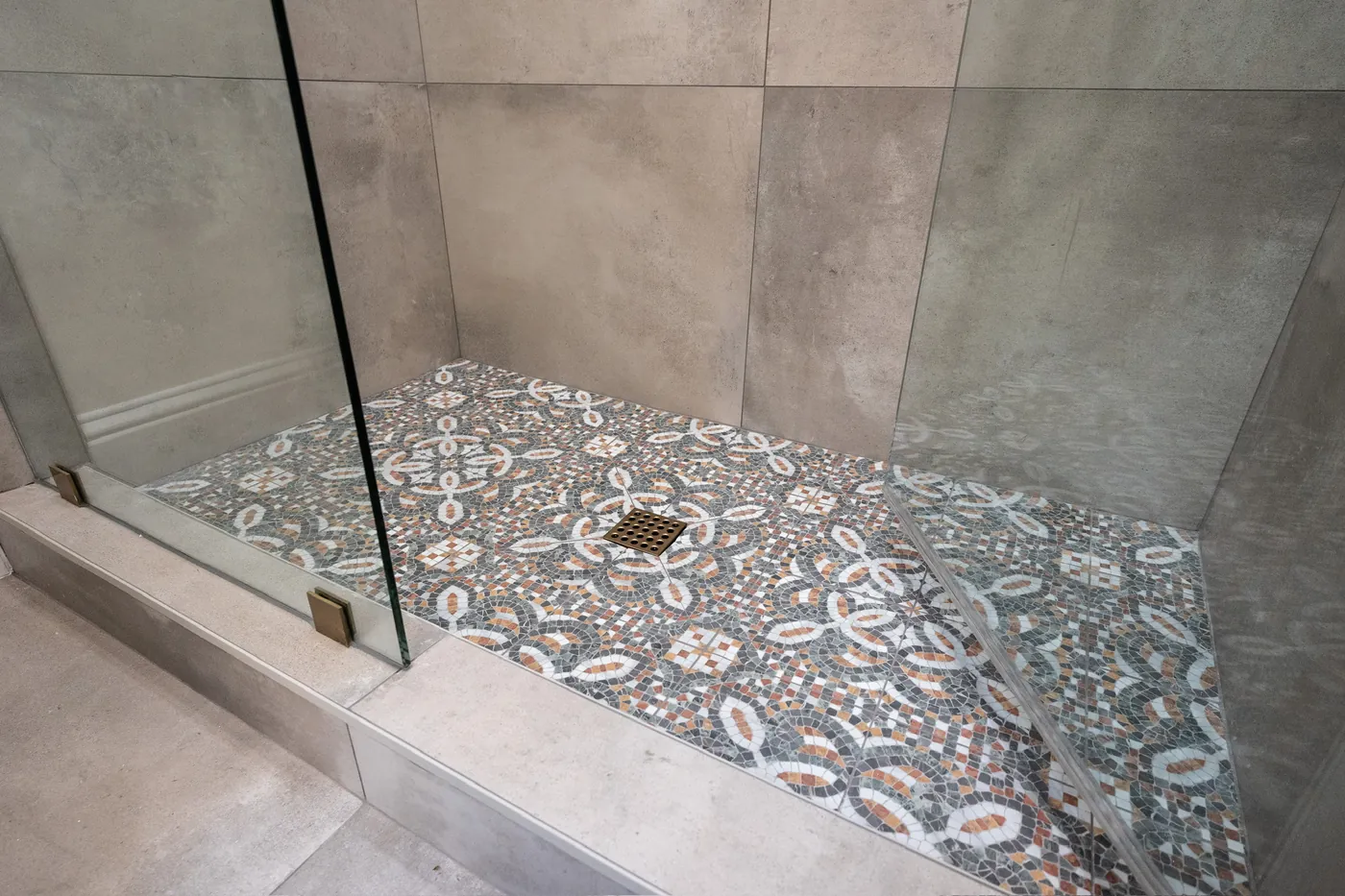 Patterned tile shower floor with a square drain