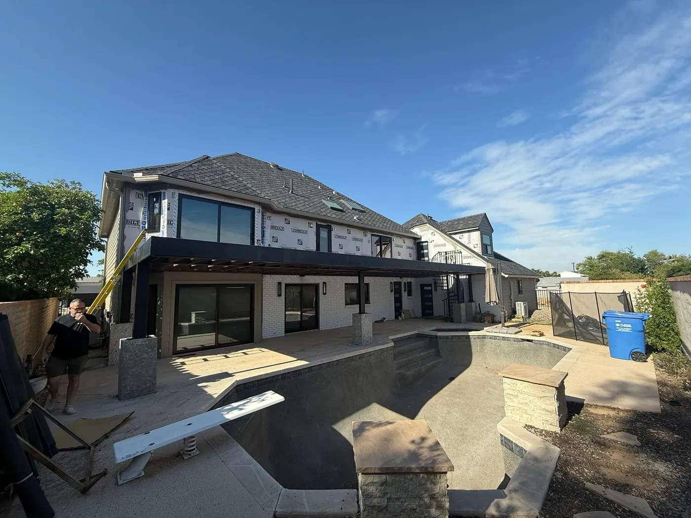 Rear elevation with the pool excavated and the surrounding hardscape underway