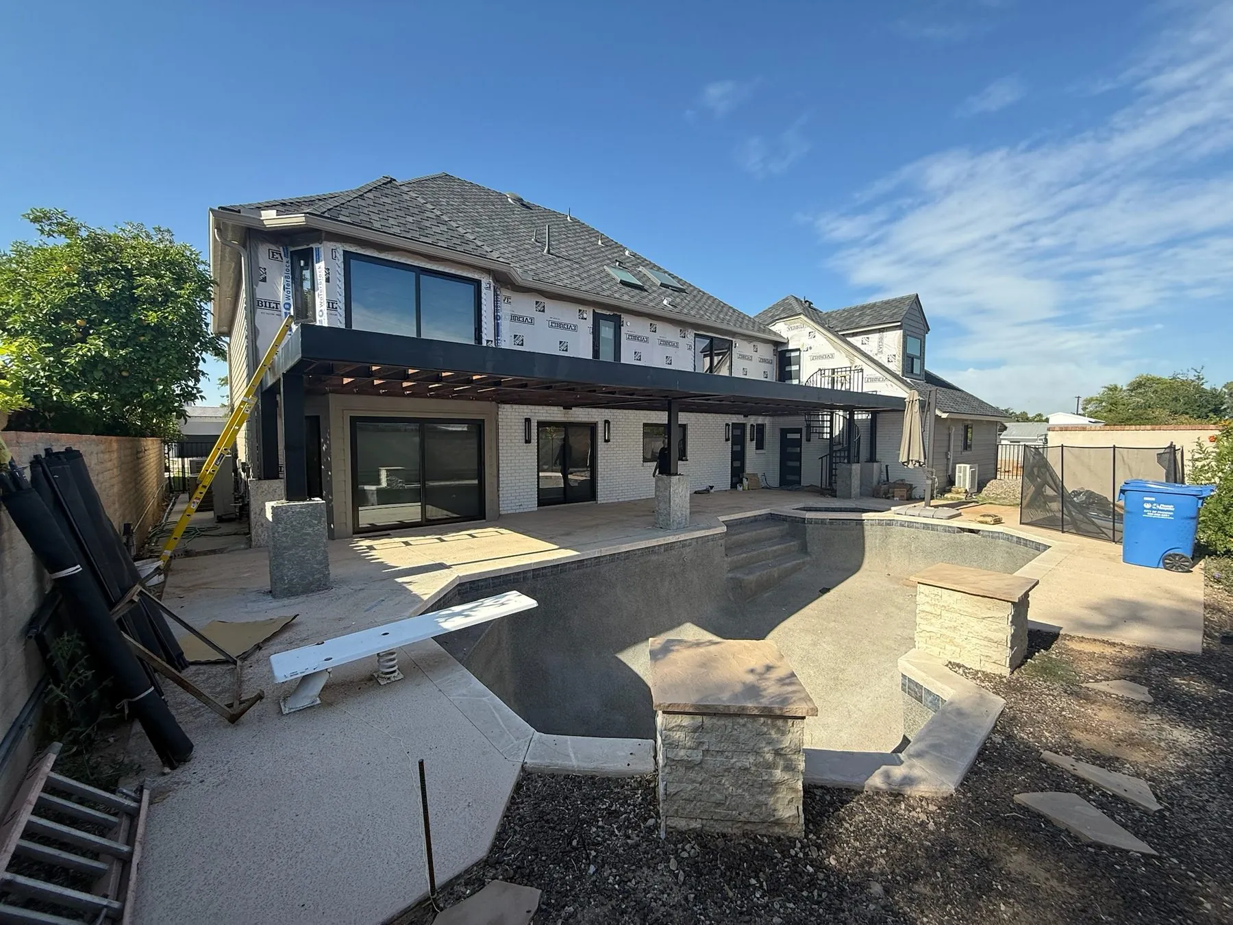 Two-storey residence under construction with the pool shell formed alongside